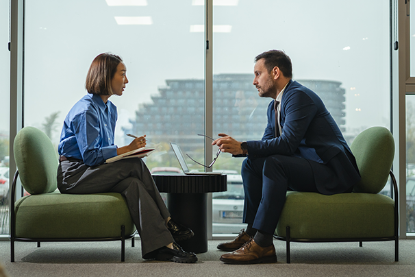 A man and woman coworker meet to discuss a career pivot.